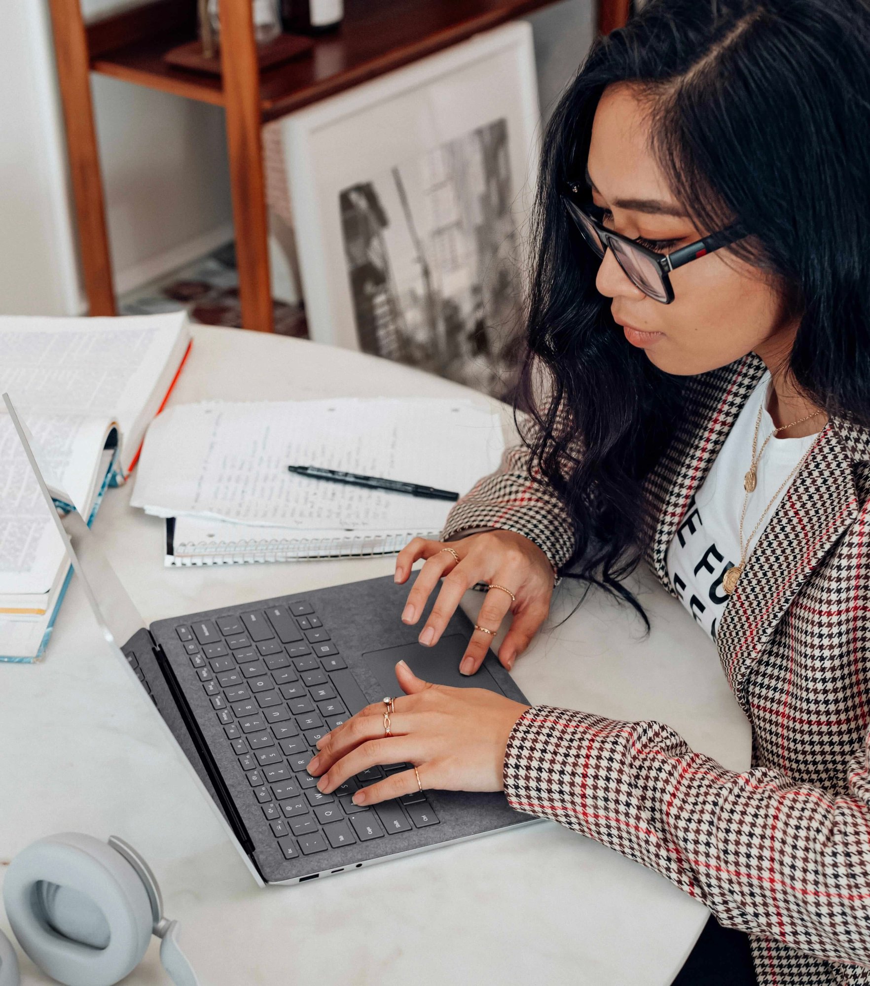 Woman is typing on a laptop