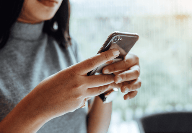 woman is typing on a phone