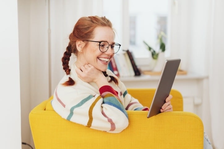 A woman readingfro a tablet