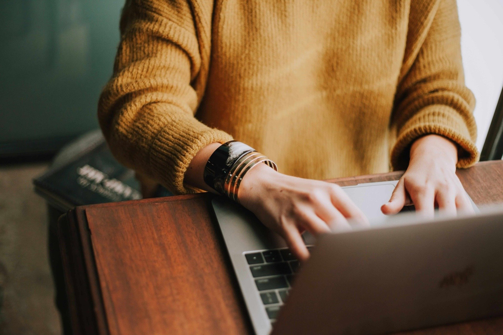 Person typing on laptop keyboard