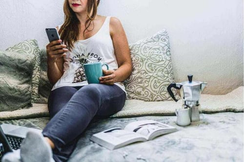 Woman on phone with coffee