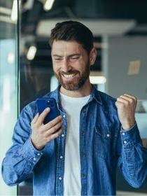 Man smiling at looking at phone