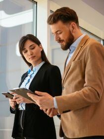 Woman and Man looking at a tablet